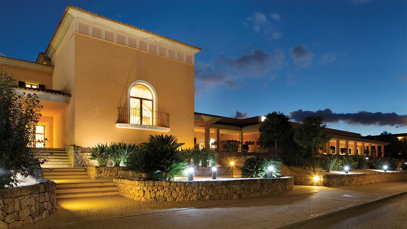 Exterior of main entrance at dusk of Marriott's Club Son Antem resort timeshare